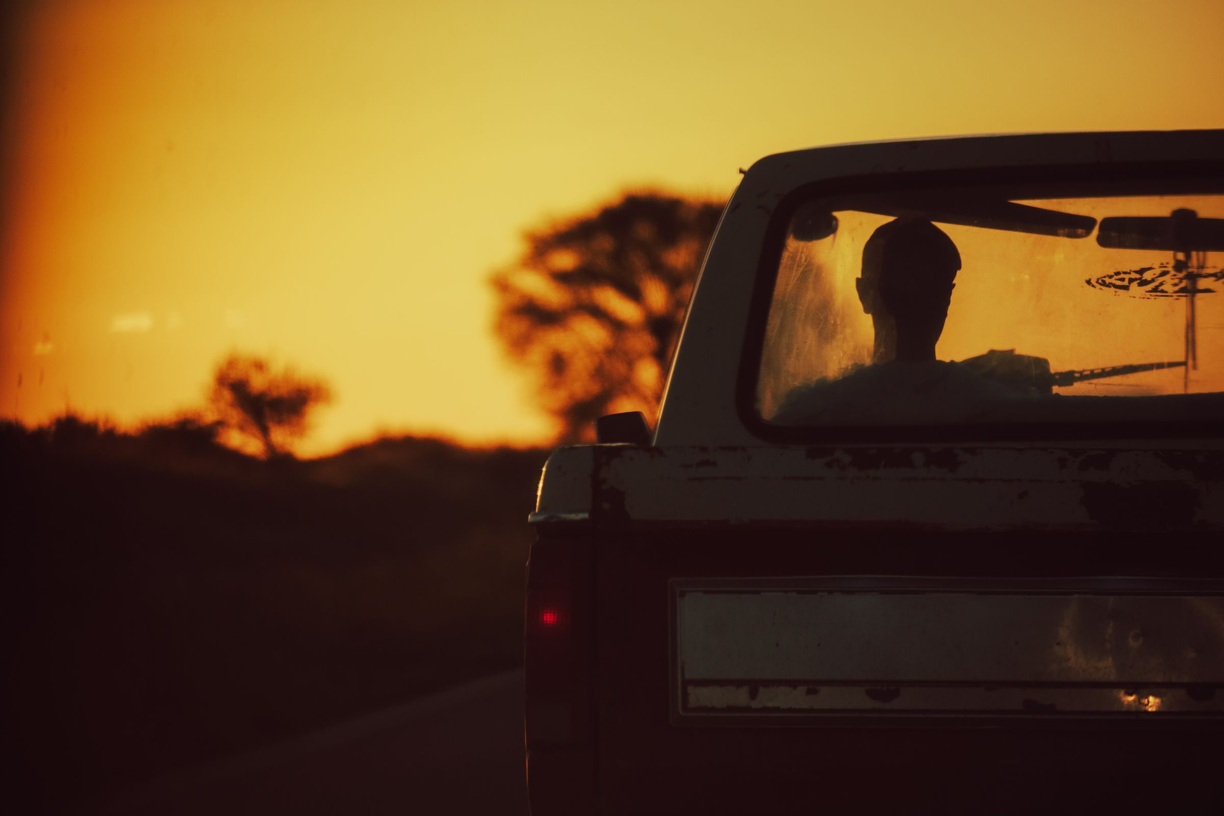 Camioneta en un camino rural al atardecer
